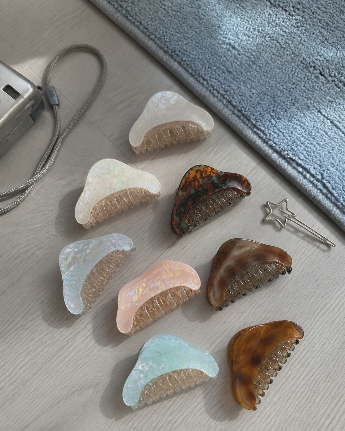 Iridescent Mini Claw Clip Set arranged on a cool gray floor