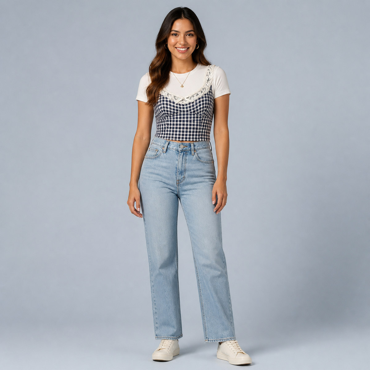 Adult model wearing the Blue Gingham Lace Cami Top on a pale gray-blue background