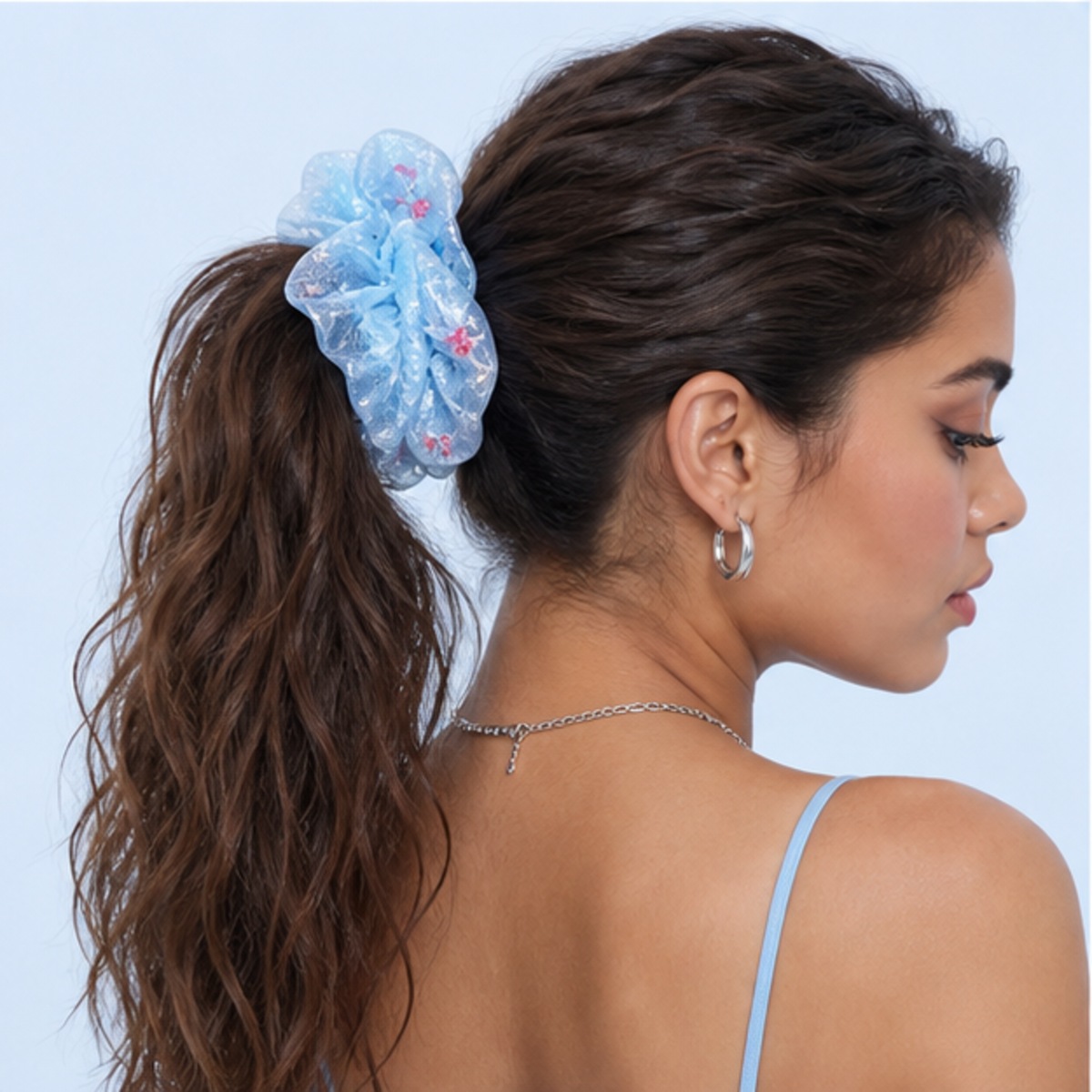 Adult model wearing the Goldfish Bubble Organza Scrunchie against a pale blue background
