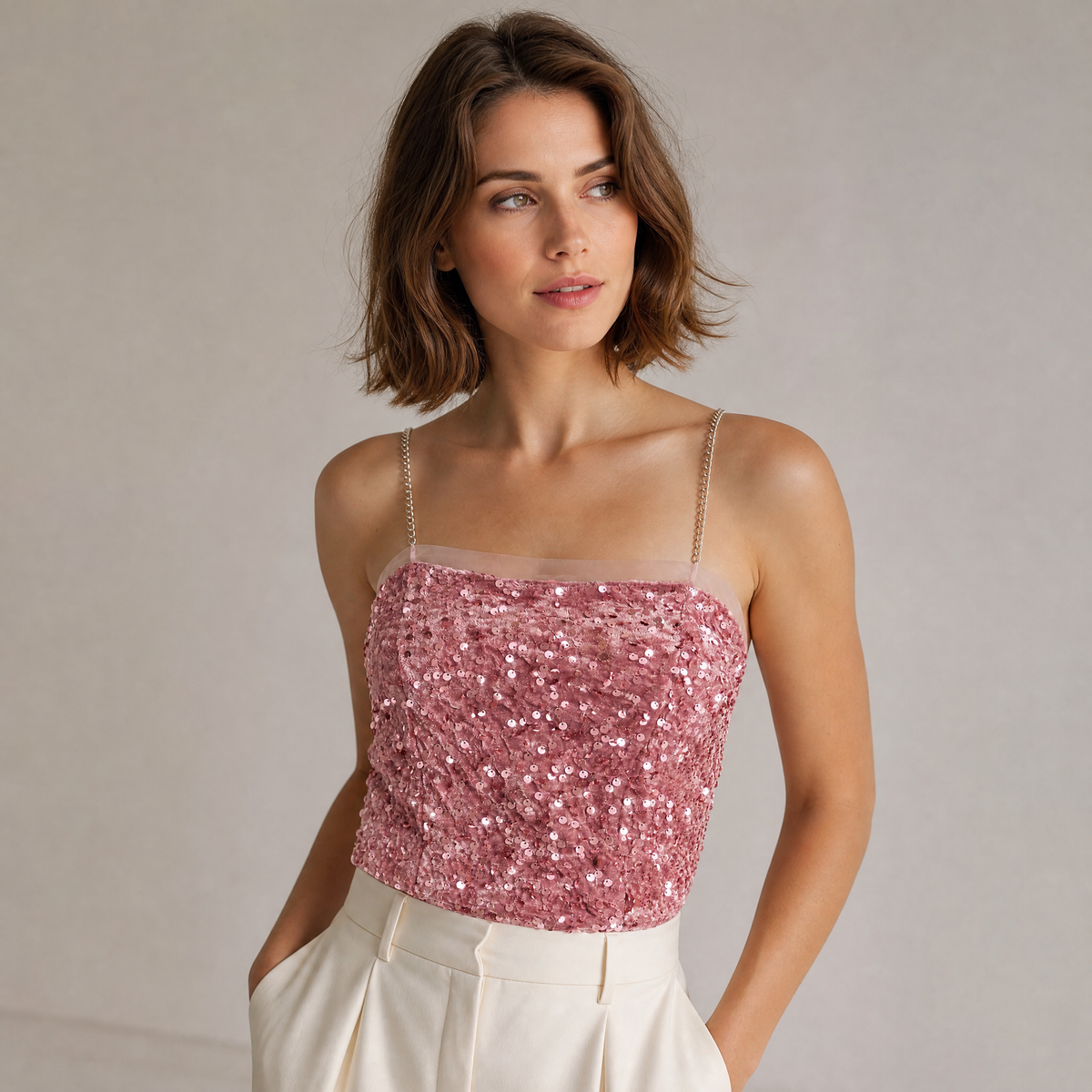 Adult model wearing the Starlight Sequin Bandeau Top in Blush Pink